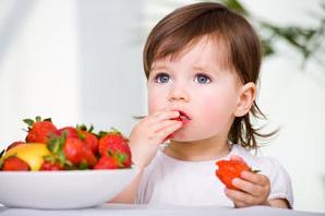 Photo of a child eating strawberries