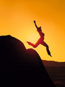 Photo of a woman leaping from a rock
