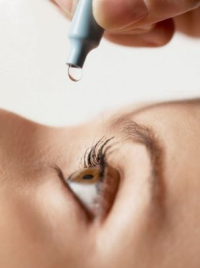 Photo of a woman using eye drops