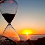 Photo of an hourglass and a sunset
