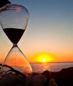 Photo of an hourglass and a sunset