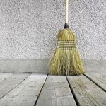 Photo of a broom on bare floorboards