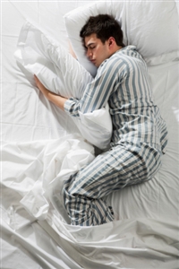 Photo of a man asleep in bed