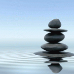 Photo of stacked stones reflected in water