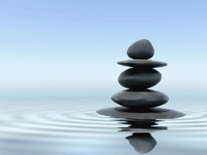 Photo of stacked stones reflected in water