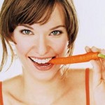 Photo of a wonam eating a carrot