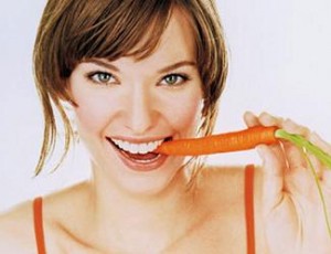 Photo of a wonam eating a carrot