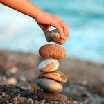 Photo of a hand stacking stones