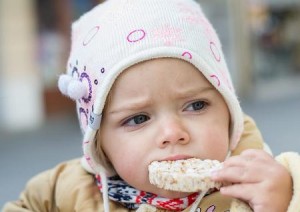 photo of a child eating a rice cake