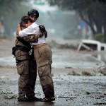 First responder comforts a victim of natural disaster