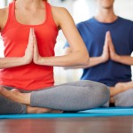 Photo of a man and woman practicing yoga