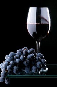 Photo of grapes and a glass of red wine