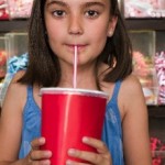 photo of a young girl drinking soda