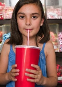 photo of a young girl drinking soda