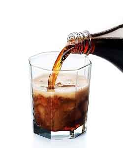photo of cola being poured into a glass