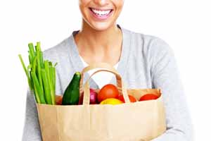 woman with a bag of healthy groceries