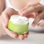 Photo of woman using face cream