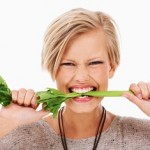photo of a woman biting a celery stick